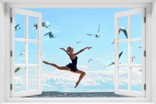 Fototapeta Naklejka Na Ścianę Okno 3D - Happy woman in black jumps on the seashore