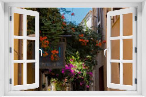 Fototapeta Naklejka Na Ścianę Okno 3D - Rethymno, Greece - August  3, 2016: Narrow venetian street in old town.