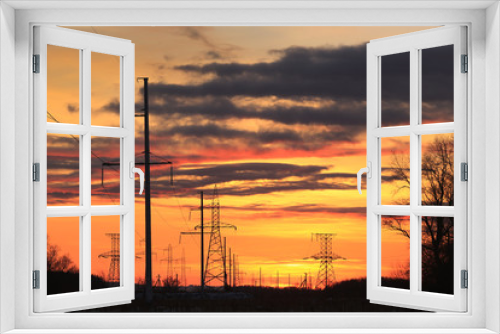 Fototapeta Naklejka Na Ścianę Okno 3D - transmission line on a background of bright red sunset