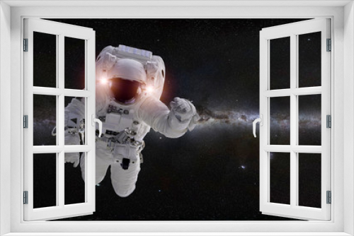 Fototapeta Naklejka Na Ścianę Okno 3D - astronaut in front of the Milky Way galaxy (elements of this image are furnished by NASA)