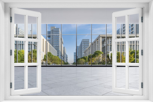 Fototapeta Naklejka Na Ścianę Okno 3D - The modern office buildings from glass window