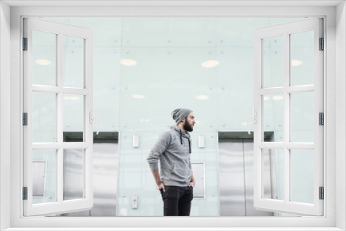 Side view of bearded man looking away between two elevators