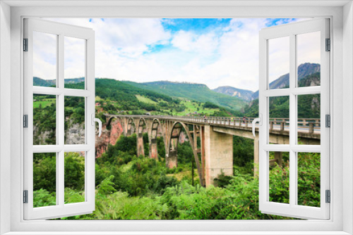Fototapeta Naklejka Na Ścianę Okno 3D - Concrete arch Durdevica Bridge over Tara River Canyon, mountain valley and forest landscape in Durmitor National Park, Montenegro.