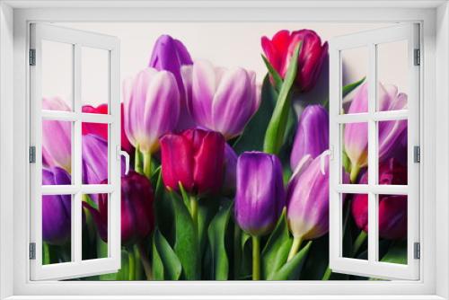 Fototapeta Naklejka Na Ścianę Okno 3D - Colorful tulips lie on table in living room. Close-up of a bouquet of tulips on a light background. Beautiful bouquet of colorful tulips. Macro shot. Spring time, Happy Mothers Day