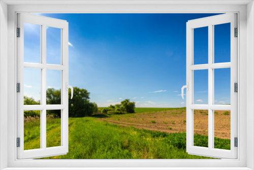 Fototapeta Naklejka Na Ścianę Okno 3D - Beautiful rural fields in early spring, on a clear day with cloudless blue sky