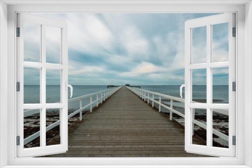 Fototapeta Naklejka Na Ścianę Okno 3D - Empty wooden pier walkway on sea shore