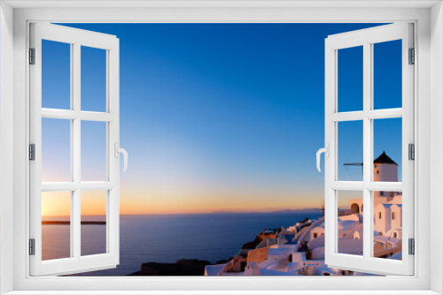 Fototapeta Naklejka Na Ścianę Okno 3D - Sunset over Oia village on Santorini island in Greece