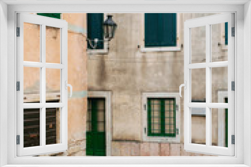 Fototapeta Naklejka Na Ścianę Okno 3D - Green window shutters. The facade of houses in Montenegro.