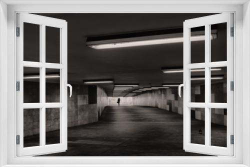 Fototapeta Naklejka Na Ścianę Okno 3D - Black and white image of an underground passage. In the background, the silhouette of a woman is visible.