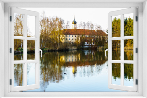 Fototapeta Naklejka Na Ścianę Okno 3D - D, Bayern, Bayerisch-Schwaben, Kirche des Kloster Oberschönenfeld mit Spiegelung in Wasserfläche, in warmes Herbstlicht getaucht