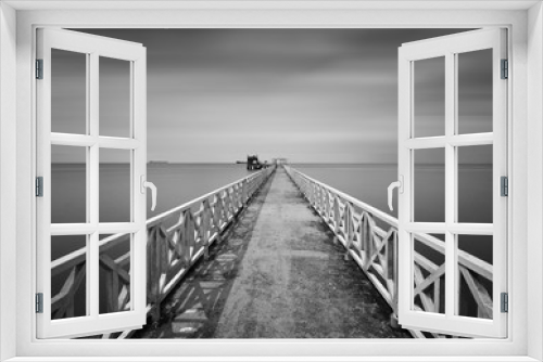 Fototapeta Naklejka Na Ścianę Okno 3D - Long exposure shot of seascape and dock in black and white.