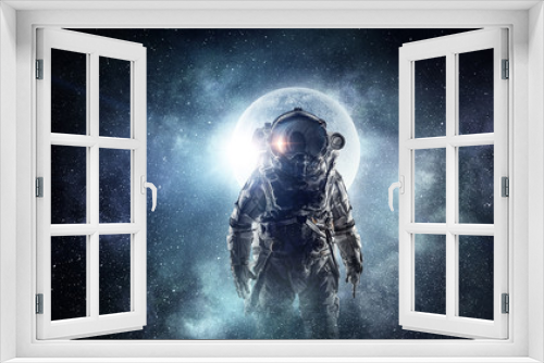 Fototapeta Naklejka Na Ścianę Okno 3D - Astronaut in outer space. Mixed media . Mixed media