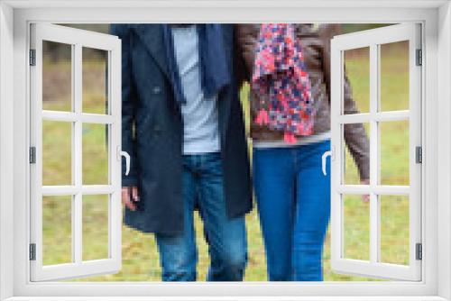 Couple walking through a park