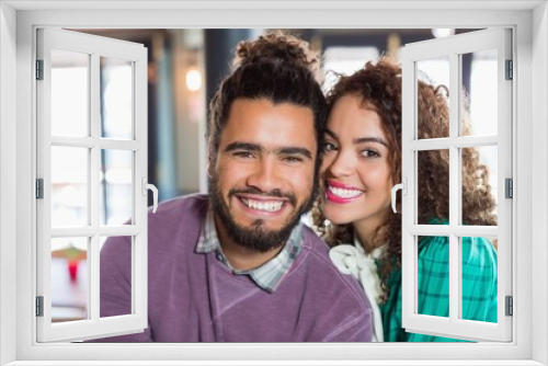 Portrait of cheerful young couple at restaurant