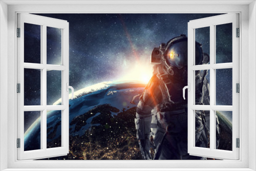 Fototapeta Naklejka Na Ścianę Okno 3D - Astronaut in outer space. Mixed media