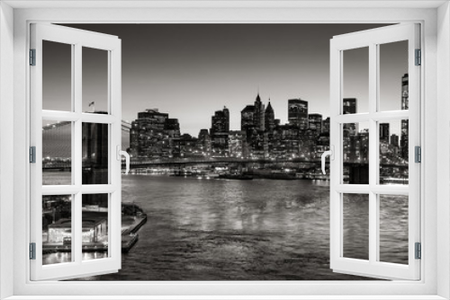 Fototapeta Naklejka Na Ścianę Okno 3D - Black & White elevated view of the Brooklyn Bridge and Lower Manhattan skyscrapers at dusk. Skyline of the Financial District with East River. New York City