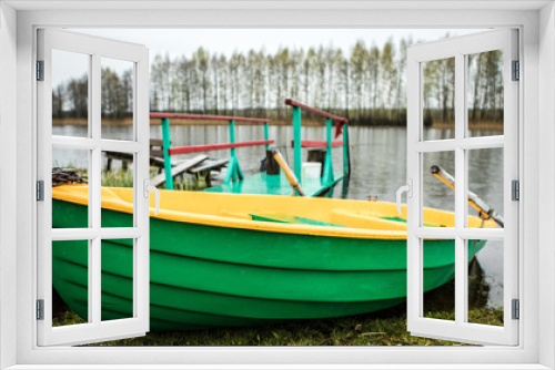 Fototapeta Naklejka Na Ścianę Okno 3D - Classic boat with oars on the river.