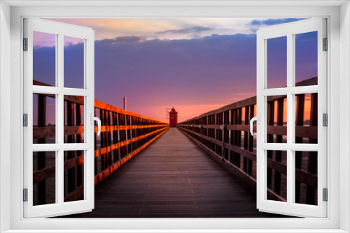 Fototapeta Naklejka Na Ścianę Okno 3D - Sunset in Lignano Sabbiadoro, with a lighthouse at the end of a pier