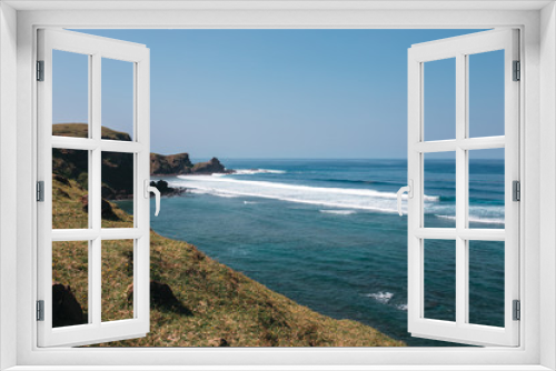 Fototapeta Naklejka Na Ścianę Okno 3D - Rocky coast of the ocean with green hills and azure water, Indonesia, Lombok