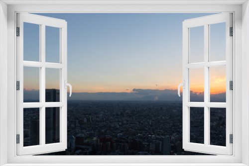 Fototapeta Naklejka Na Ścianę Okno 3D - Sunset sky view from Tokyo Metropolitan Government Building observation, through glass