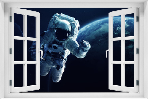 Fototapeta Naklejka Na Ścianę Okno 3D - Astronaut in front of the Earth planet. Elements of this image furnished by NASA