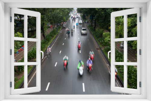 Fototapeta Naklejka Na Ścianę Okno 3D - HO CHI MINH, VIETNAM - MAY 13 2017: Undefined motorcycle traffic in rain. Is located in the South of Vietnam, is the country's largest city
