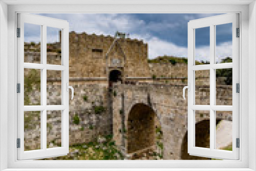 Fototapeta Naklejka Na Ścianę Okno 3D - Gate of Saint John, bridge leading to it and moat at Rhodes old town, Greece 