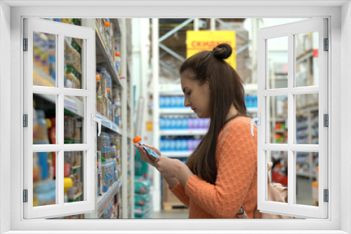 Young mom buys baby food in supermarket