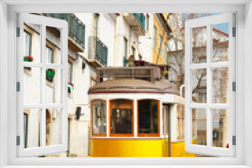 Fototapeta Naklejka Na Ścianę Okno 3D - Famous vintage yellow 28 tram on street of Alfama, the oldest district of the Old Town, Lisbon, Portugal
