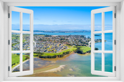 Fototapeta Naklejka Na Ścianę Okno 3D - Aerial view on sunny beach with residential suburb on the background. Auckland, New Zealand.