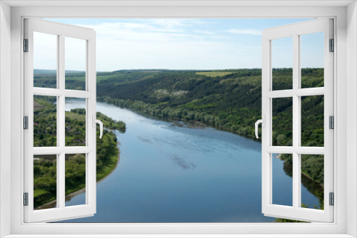 Fototapeta Naklejka Na Ścianę Okno 3D - storks fly over the river a panorama of the mouth of the river a flight of storks great views of the river the panorama of the river Dnister Ukrainian river