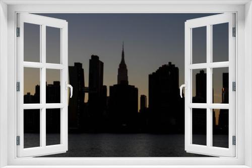 Fototapeta Naklejka Na Ścianę Okno 3D - Silhouette Buildings of Manhattan in the dark before night