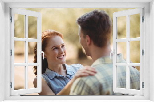 Happy young couple looking at each other at olive farm