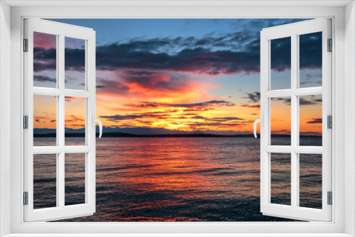 Fototapeta Naklejka Na Ścianę Okno 3D - Alki Beach Sunset with Olympic Range Silhouetted and Water Reflections. .