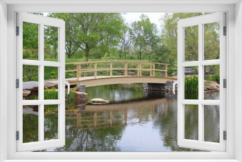 Fototapeta Naklejka Na Ścianę Okno 3D - The wood bridge over the pond at the park.