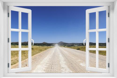 Fototapeta Naklejka Na Ścianę Okno 3D - Landschaft mit gerader Strasse / Landschaft mit gerader Strasse bis zum Horizont, Namibia, Afrika.