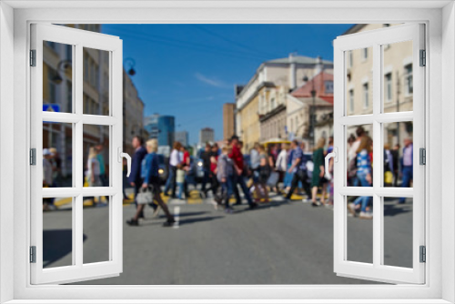 Fototapeta Naklejka Na Ścianę Okno 3D - People walk on a pedestrian crossing, blurred background
