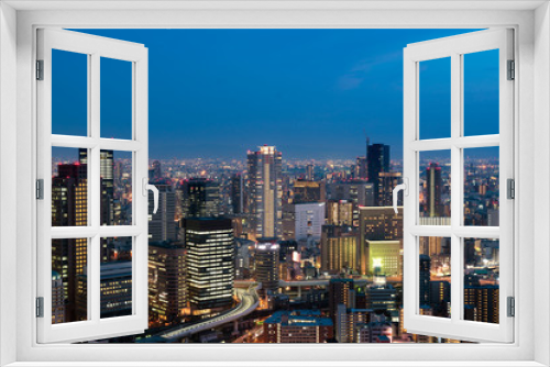 Fototapeta Naklejka Na Ścianę Okno 3D - Osaka downtown city skyline at the landmark Umeda District in Osaka, Japan.