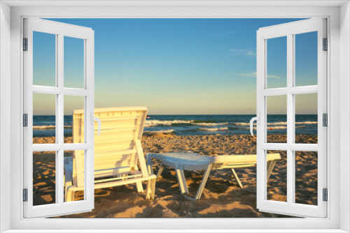 Fototapeta Naklejka Na Ścianę Okno 3D - Two deckchairs on the beach with bright sun and waves