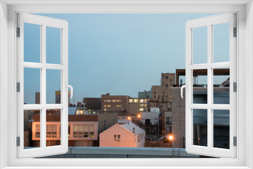 Fototapeta Naklejka Na Ścianę Okno 3D - Lovely shot of city apartment buildings from a rooftop in the evening, just after sunset.