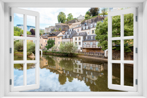 Fototapeta Naklejka Na Ścianę Okno 3D - Sunset view on the old buildings near the river in Grund district of the old town of Luxembourg city