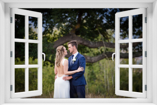 Beautiful bride and her groom on their wedding day looking happy and in love at the start of their marriage