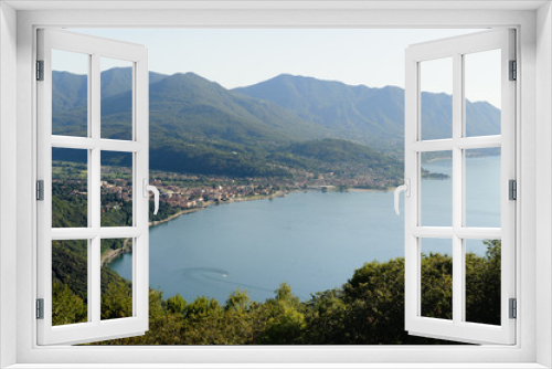 Fototapeta Naklejka Na Ścianę Okno 3D - View from above on Luino and Lago Maggiore with the mountain peaks in the background