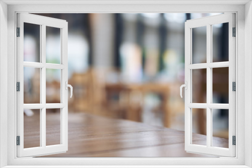 Wooden table and chair in cafe with blur bokeh abstract vintage background