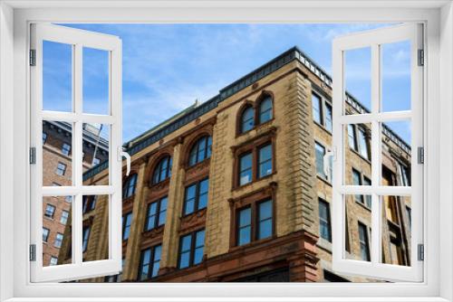 An old historical building with the large windows in the old port of Montreal, Canada