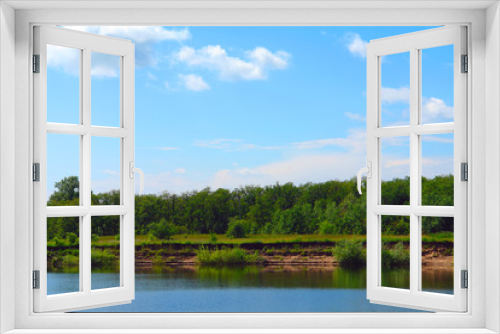 Fototapeta Naklejka Na Ścianę Okno 3D - Landscape with clouds in blue sky over river. At the lake a precipitous shore