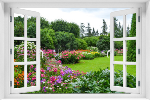 Fototapeta Naklejka Na Ścianę Okno 3D - Summer garden in Saint Petersburg city, landscape. Beautiful park, flowers and trees view, green lawn, grass. Famous historical place. For posters, interior decoration, calendars, prints designs.