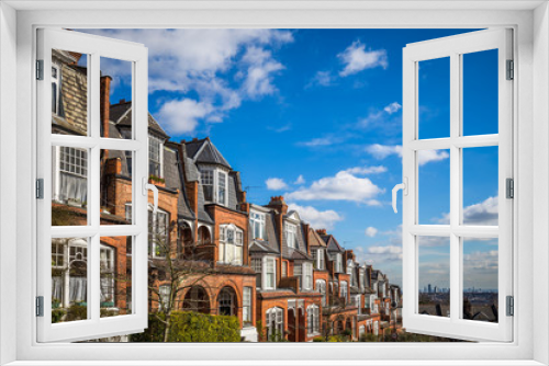 Fototapeta Naklejka Na Ścianę Okno 3D - London, England - Traditional brick houses and flats on a nice summer morning with blue sky and clouds taken from Muswell Hill