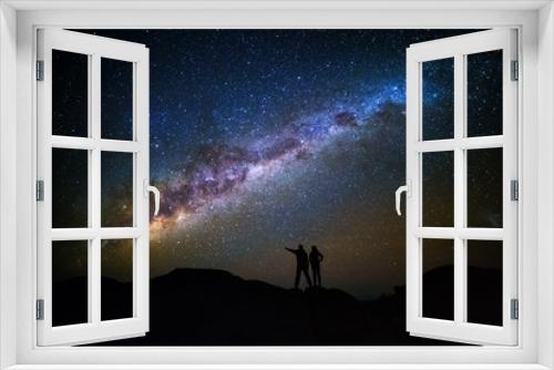 Fototapeta Naklejka Na Ścianę Okno 3D - Landscape with Milky Way. Night sky with stars and silhouette of a couple on the mountain.