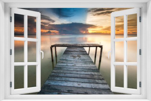 Fototapeta Naklejka Na Ścianę Okno 3D - View of beautiful sunset with wooden jetty. image contain soft focus due to long expose.